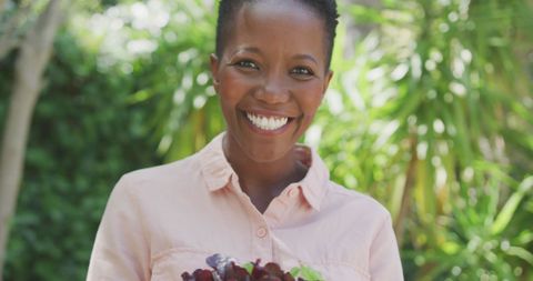 Smiling African American Woman Enjoying Lush Garden