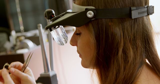 Focused Female Jeweler Working with Magnifying Headband - Download Free Stock Images Pikwizard.com