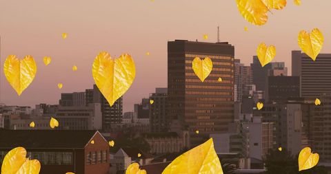 Golden Autumn Leaves Floating Over Urban Skyline