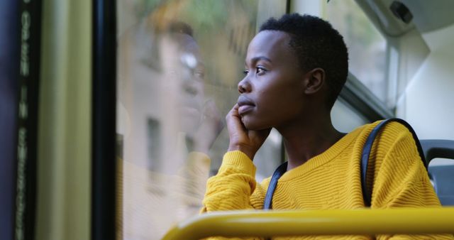 Young Woman in Yellow Sweater Looking Out of Bus Window - Download Free Stock Images Pikwizard.com