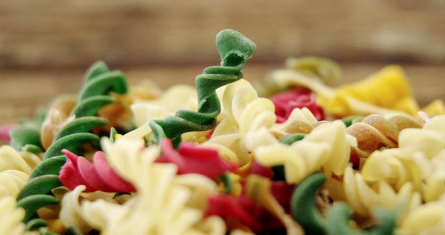 Colorful Fusilli Pasta Pile, Uncooked Rotini on Rustic Surface - Download Free Stock Images Pikwizard.com