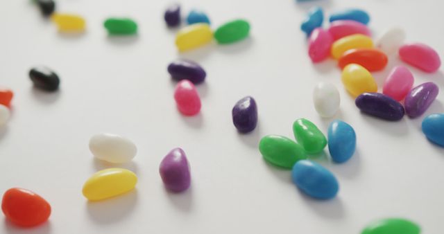 Colorful Jelly Beans Scattered on White Surface - Download Free Stock Images Pikwizard.com