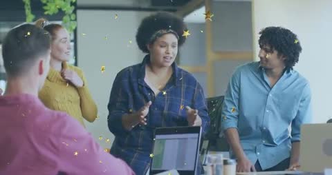 Team presenting and launching pitch with gold star confetti in modern coworking space