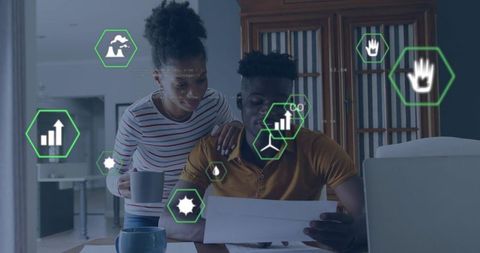 Young couple reviewing household budget and bills with digital analytics overlay, laptop