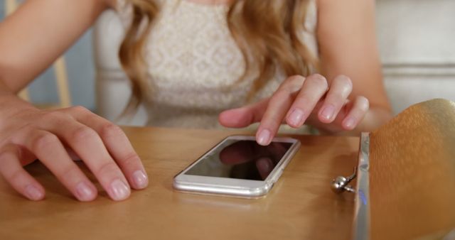 This close-up image features a woman's hands using a smartphone. Ideal for depicting modern technology use, social media interactions, and digital communication. Appropriate for websites, blogs, or articles focused on lifestyle, technology, communication, and connectivity themes.