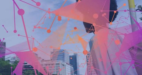 Standing woman in pale coat and scarf with pink geometric overlay over city skyline