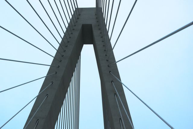 Modern cable-stayed bridge against a clear sky with architectural and engineering design elements. Ideal for use in projects involving city infrastructure, urban development, or architectural studies. Suitable for illustrating modern engineering feats, urban landscapes, and transportation themes.