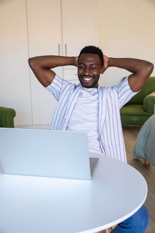 Relaxed Man Enjoying Screen Time at Home on Laptop