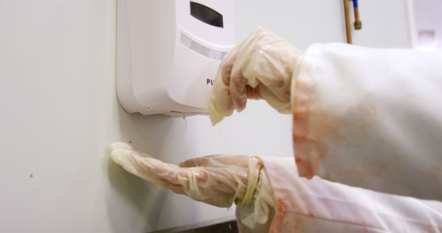 Healthcare Worker Using Wall-Mounted Hand Sanitizer Dispenser - Download Free Stock Images Pikwizard.com