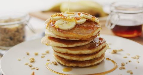Delicious pancakes with sliced bananas and syrup drizzle