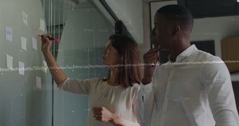 Team Collaborating on Project While Analyzing Data