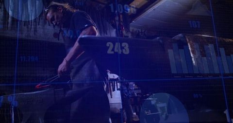 Blacksmith forging steel with digital data overlay, industrial workshop analytics concept