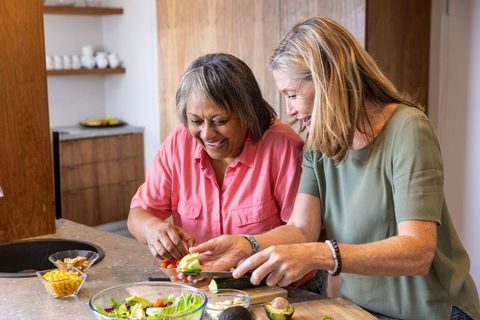 Senior Women Joyfully Preparing Healthy Salad Together