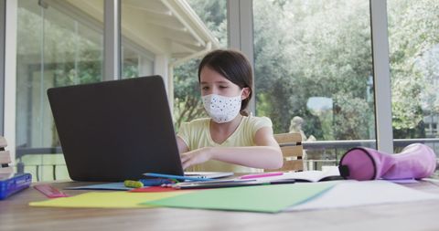 Girl Wearing Mask Studying Remotely at Home During Pandemic - Download Free Stock Images Pikwizard.com