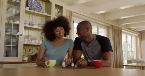 Happy Couple Enjoys Tea and Technology Together