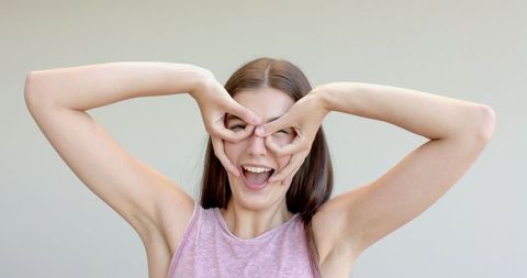 Teen Girl Making Playful Hand Gesture Indoors - Download Free Stock Images Pikwizard.com