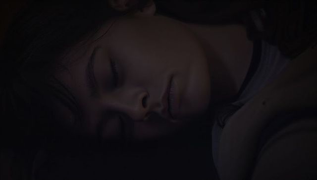 Sleeping woman resting in low light intimate bedroom closeup portrait with loose hair