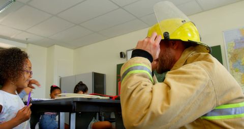 Firefighter teaching kids fire safety in classroom