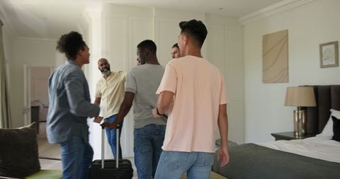 Friends Carrying Luggage into Hotel Room for Weekend Adventure