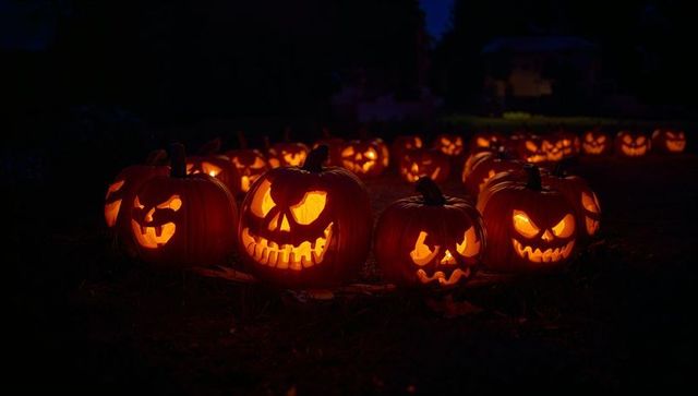 Glowing jack-o'-lantern display on autumn night