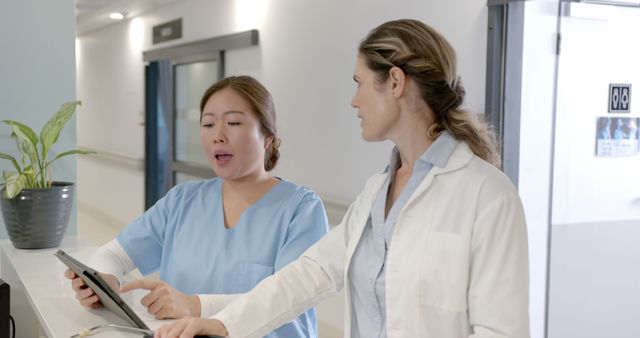 Healthcare Professionals Discussing Medical Records in Hospital Corridor - Download Free Stock Images Pikwizard.com