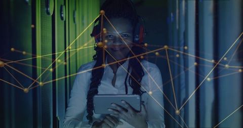 Engineer analyzing network in data center aisle