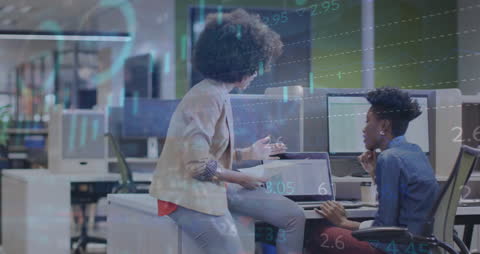 Businesswomen Discuss Stock Market Data in Office with Digital Interface