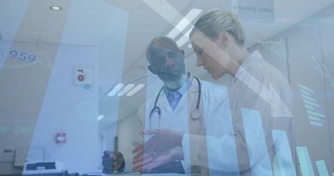 Clinicians Reviewing Digital Patient Data at Nursing Station Collaborating on Care Decisions