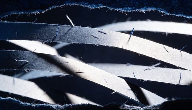 Creating layered torn paper strips with frayed fibers and moody blue contrast lighting