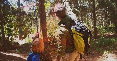 Father and Son Hiking Through Forest wilderness