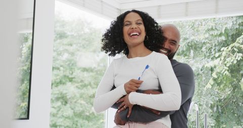 Happy Biracial Couple Embracing While Brushing Teeth - Download Free Stock Images Pikwizard.com