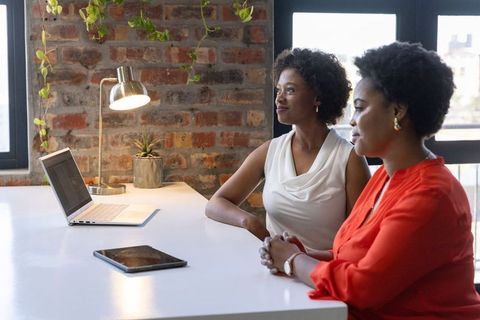 African American Businesswomen Collaborating at Modern Office Desk