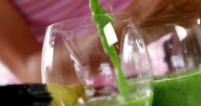 A close-up view of a vibrant green smoothie in a glass, with a focus on the fresh aloe vera garnish, with copy space. A healthy and refreshing beverage option is highlighted, emphasizing wellness and natural ingredients.