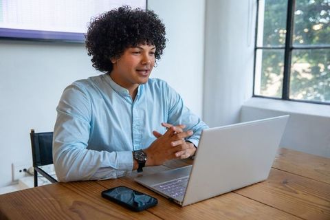 Young Professional Conducting Virtual Meeting in Modern Office