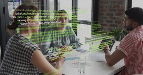 Software team collaborating over ui design, code review and product planning at office table