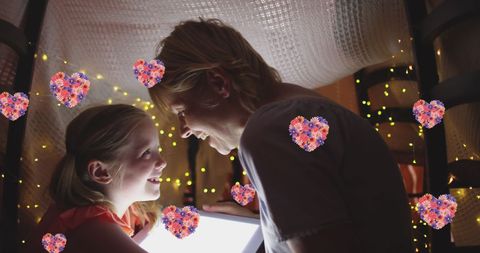 Mother and Daughter Bonding in Cozy Fort with Hearts