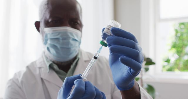 Experienced Doctor Preparing Vaccine Injection with Syringe and Vial - Download Free Stock Images Pikwizard.com