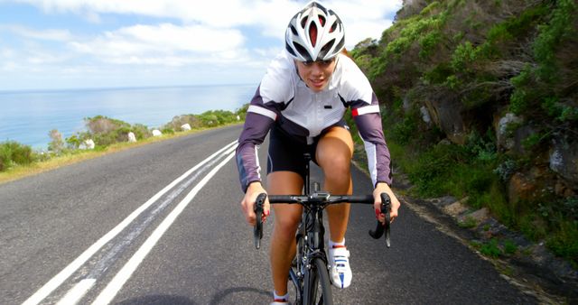Cyclist Enjoying Coastal Road with Scenic Ocean View - Download Free Stock Images Pikwizard.com