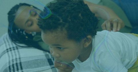 Mother Supporting Toddler Boy on Bedroom Bed Coziness and Affection