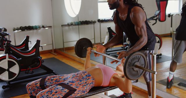 Personal Trainer Assisting Woman with Bench Press in Gym - Download Free Stock Images Pikwizard.com