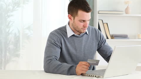 Man Shopping Online with Payment Card at Home