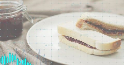 Displaying jam sandwich on ceramic plate with rustic breakfast jar and digital overlay