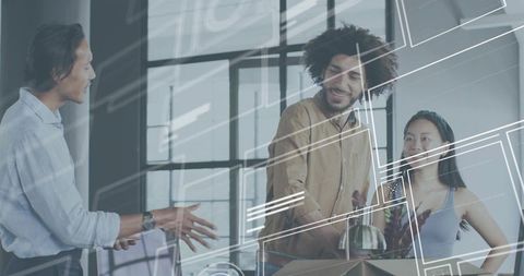 Young team collaborating in open-plan office, unpacking boxes and planning workspace layout