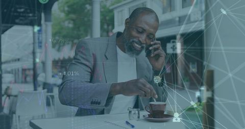 African American Man Discussing Data at Cafe with Technology Overlay