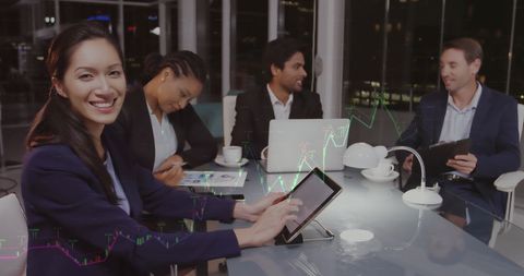 Diverse Business Team Analyzing Data in Night Office Environment