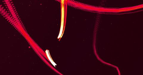 Glowing red lines in motion on black background