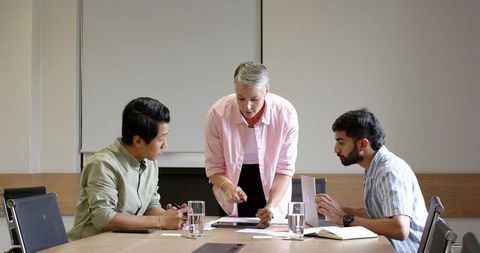 Business professionals collaborating in boardroom meeting