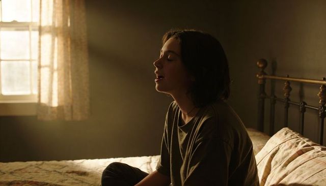Teen Woman Sitting on Bed in Warm Sunbeam, Quiet Solitude, Minimalist Bedroom Morning Mood