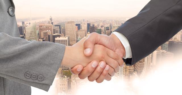 Digital composite of Close-up of handshake with buildings in background
