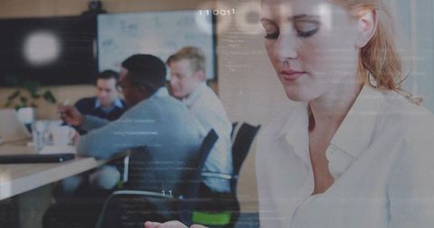 Professional woman engaged with tablet during modern meeting